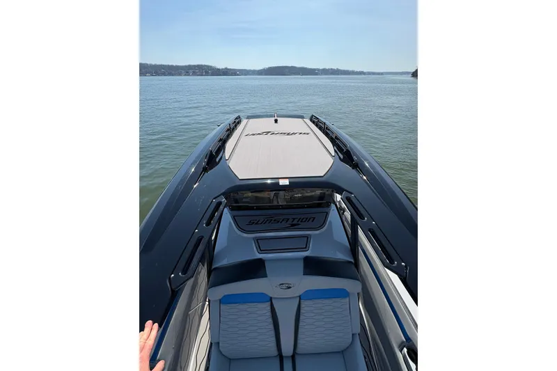 Slide: The Image of 2024 Sunsation 32 CCX boat on calm water, showcasing sleek design and spacious seating. - 28