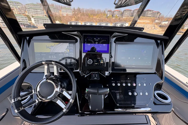 Slide: The Image of 2024 Sunsation 32 CCX boat dashboard with advanced navigation and control systems. - 3