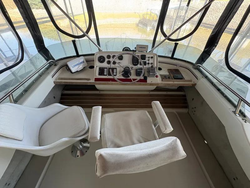 Slide: The Image of 1983 Mainship 34 Mark III cockpit with steering wheel and instruments. - 13