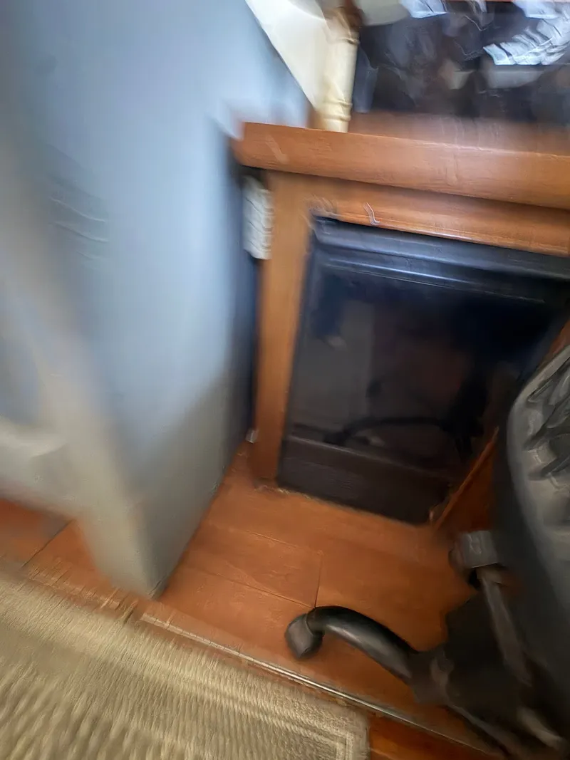 Slide: The Image of Interior of a 1983 Mainship 34 Mark III, featuring wood flooring and furniture. - 31