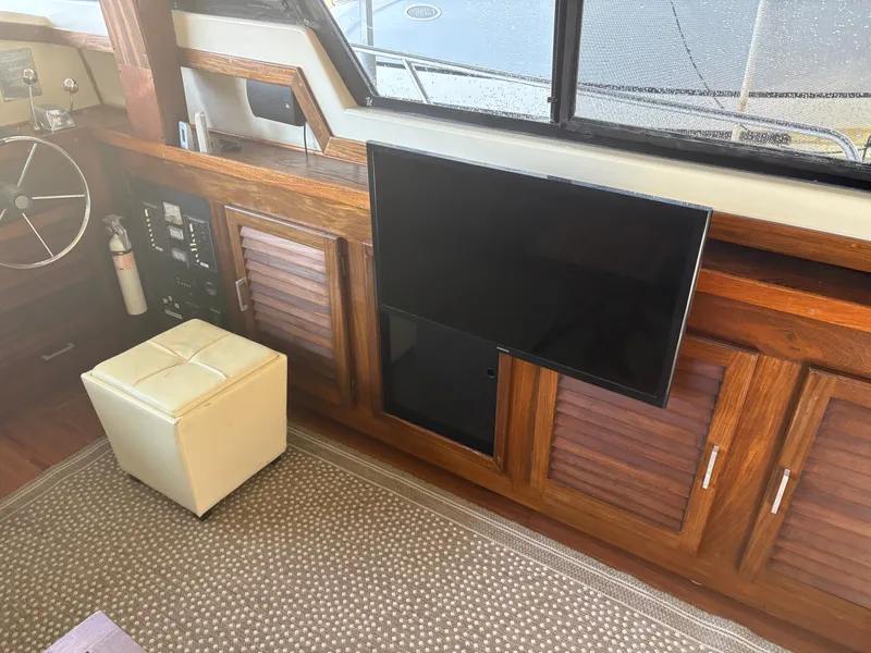Slide: The Image of Interior of a 1983 Mainship 34 Mark III with wood paneling and TV. - 32