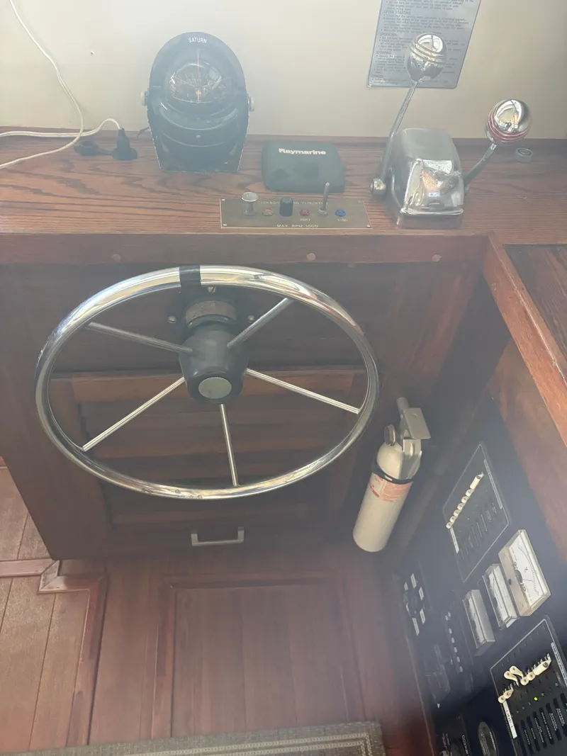 Slide: The Image of 1983 Mainship 34 Mark III helm with compass and throttle controls. - 42