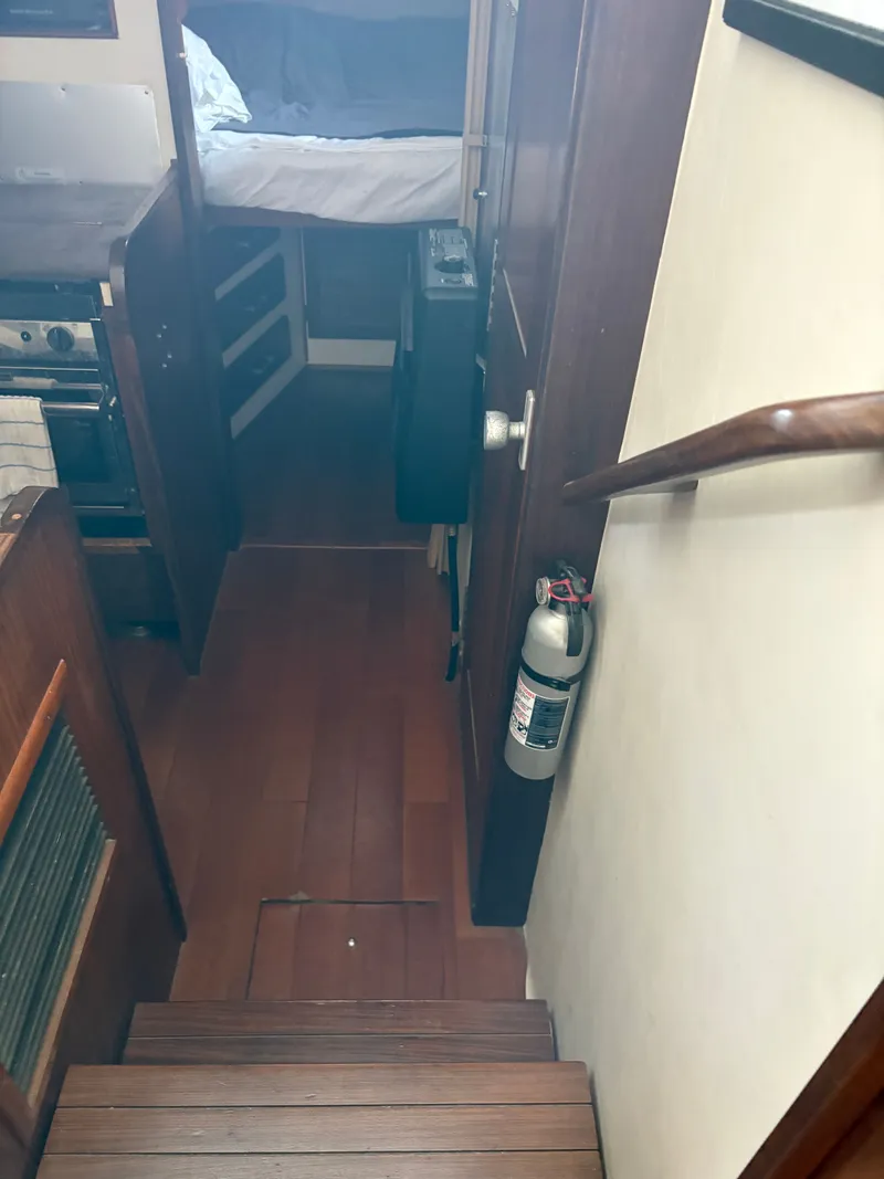 Slide: The Image of Interior of a 1983 Mainship 34 Mark III with stairs and fire extinguisher. - 45