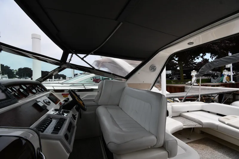 Slide: The Image of 1994 Sea Ray 400 Express Cruiser interior with helm and seating area. - 14