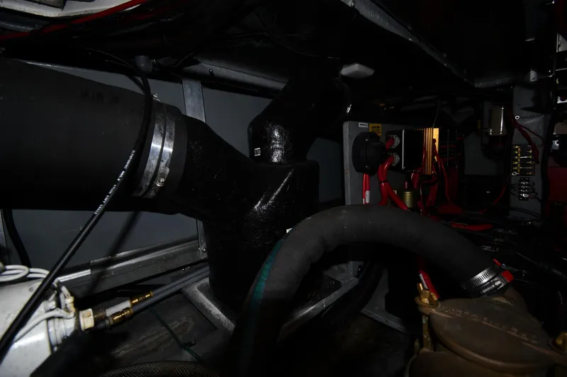 Slide: The Image of Engine room of a 1994 Sea Ray 400 Express Cruiser with visible hoses and wiring. - 46