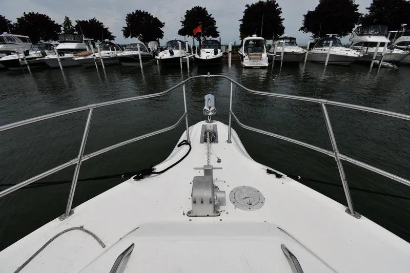 Slide: The Image of Bow view of 1994 Sea Ray 400 Express Cruiser docked at marina. - 4
