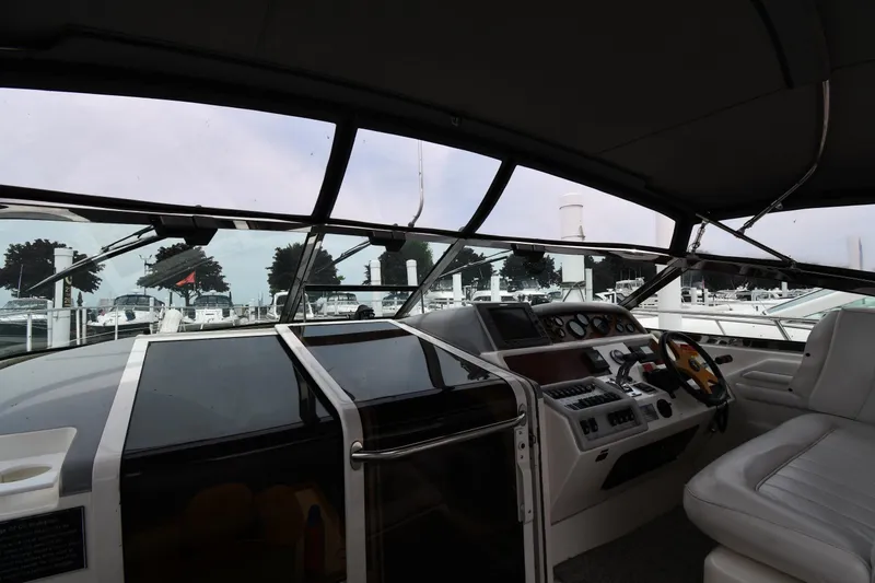 Slide: The Image of Interior view of 1994 Sea Ray 400 Express Cruiser cockpit with steering wheel and controls. - 8