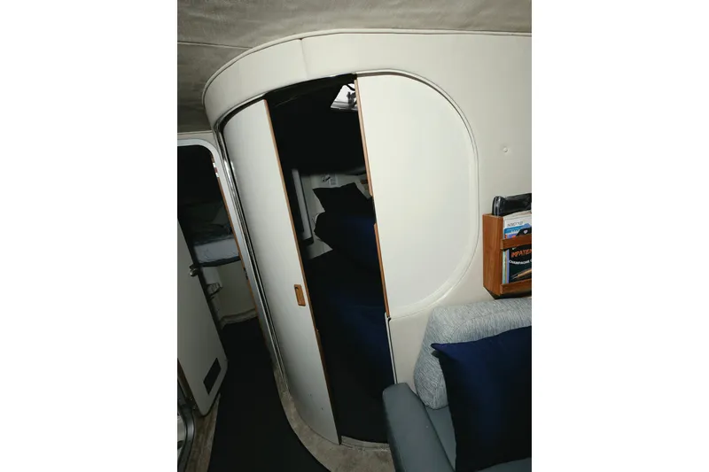 Slide: The Image of Interior of 1994 Sea Ray 400 Express Cruiser with curved door and cozy seating area. - 14
