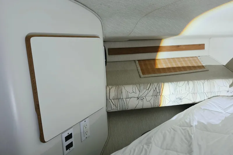 Slide: The Image of Interior cabin of a 1994 Sea Ray 400 Express Cruiser, featuring a bed and wall panel. - 16