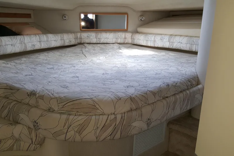 Slide: The Image of 1994 Sea Ray 400 Express Cruiser cabin with floral-patterned bedding and cozy interior. - 17