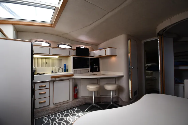 Slide: The Image of Interior of 1994 Sea Ray 400 Express Cruiser with kitchenette and seating area. - 31