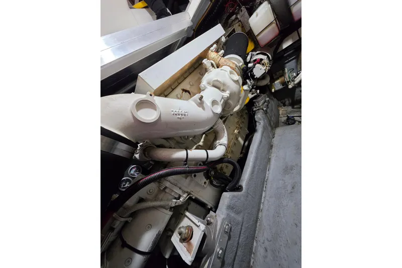 Slide: The Image of Engine compartment of a 1994 Sea Ray 400 Express Cruiser, showcasing mechanical components. - 27