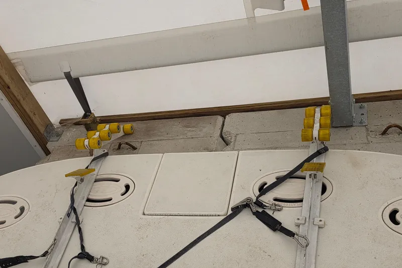 Slide: The Image of 1994 Sea Ray 400 Express Cruiser boat trailer setup with yellow rollers and straps. - 3