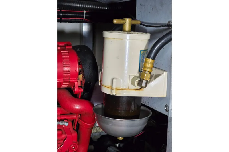 Slide: The Image of Engine component of 1994 Sea Ray 400 Express Cruiser with filter and red machinery. - 31