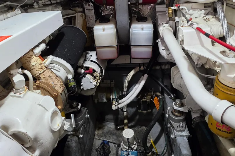 Slide: The Image of Engine room of a 1994 Sea Ray 400 Express Cruiser, showcasing mechanical components and systems. - 32
