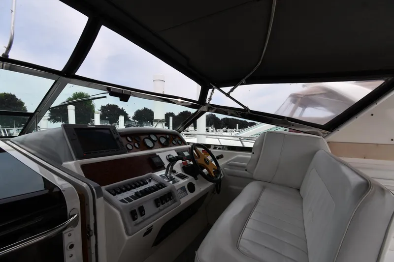 Slide: The Image of Cockpit of 1994 Sea Ray 400 Express Cruiser with steering wheel and control panel. - 9