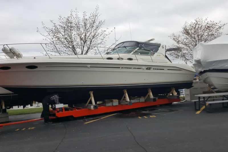 Slide: The Image of 1994 Sea Ray 400 Express Cruiser on dry dock, ready for maintenance. - 4