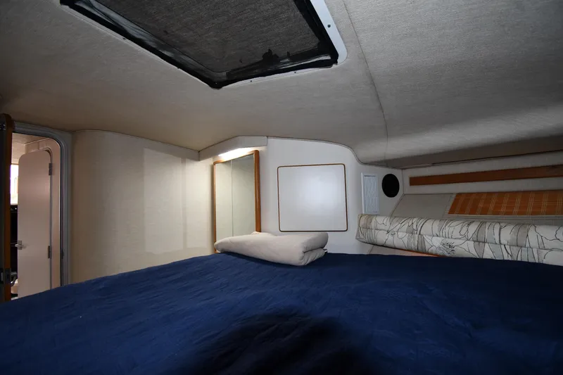 Slide: The Image of Interior cabin of 1994 Sea Ray 400 Express Cruiser with bed and skylight. - 28