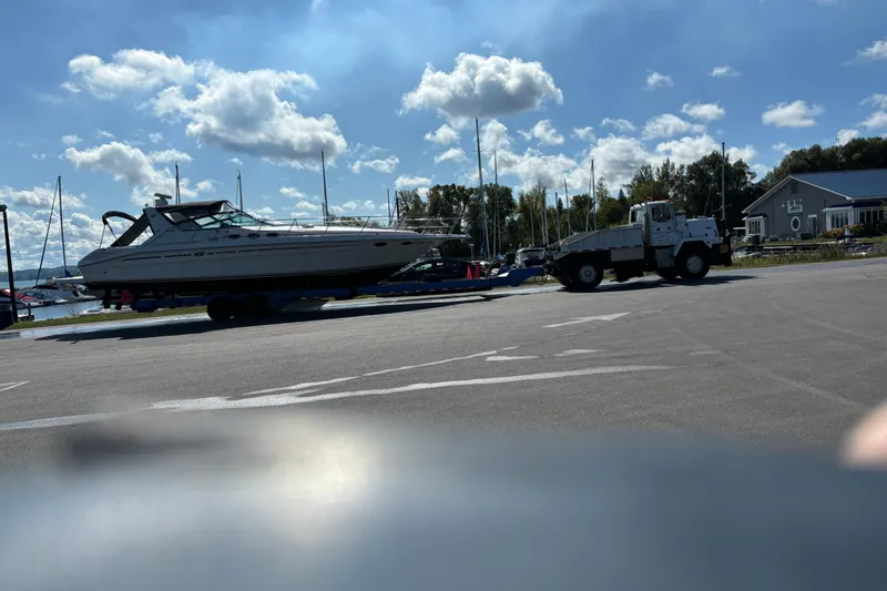Slide: The Image of 1994 Sea Ray 400 Express Cruiser on trailer, sunny marina backdrop. - 6