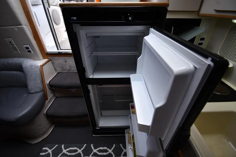 Slide: The Image of Interior of a 1994 Sea Ray 400 Express Cruiser showing an open refrigerator. - 39