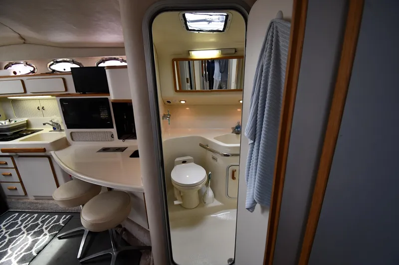 Slide: The Image of Interior of 1994 Sea Ray 400 Express Cruiser, featuring kitchen and bathroom amenities. - 35
