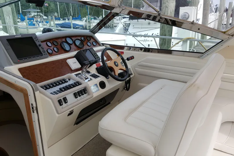 Slide: The Image of 1994 Sea Ray 400 Express Cruiser helm with modern controls and luxurious seating. - 9