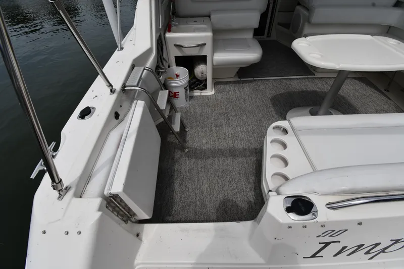Slide: The Image of 1994 Sea Ray 400 Express Cruiser interior with seating, table, and water view. - 21
