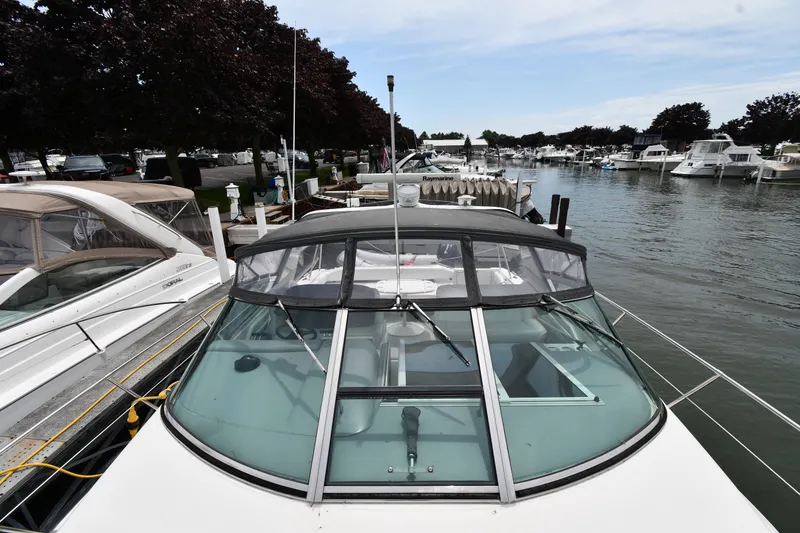 Slide: The Image of 1994 Sea Ray 400 Express Cruiser docked at a marina, surrounded by other boats. - 6