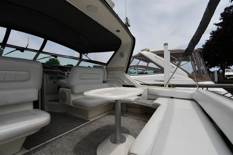 Slide: The Image of 1994 Sea Ray 400 Express Cruiser interior with white seating and table. - 16