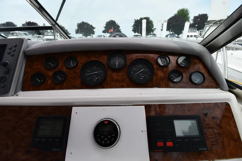 Slide: The Image of 1994 Sea Ray 400 Express Cruiser dashboard with gauges and controls. - 11