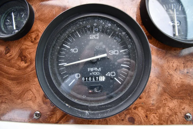 Slide: The Image of 1994 Sea Ray 400 Express Cruiser RPM gauge on wooden dashboard. - 12