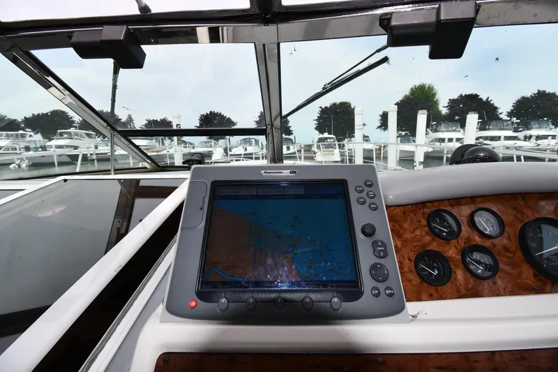 Slide: The Image of Dashboard of a 1994 Sea Ray 400 Express Cruiser with navigation system and gauges. - 10