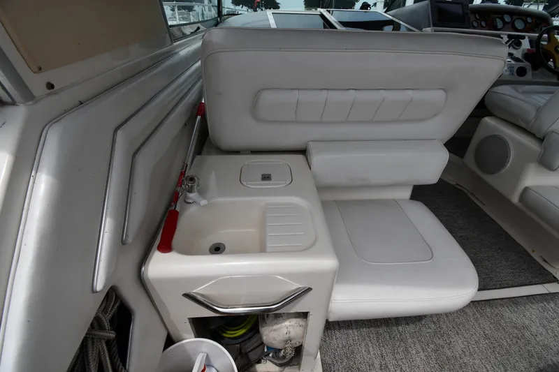Slide: The Image of Interior of 1994 Sea Ray 400 Express Cruiser with white seating and compact sink area. - 20