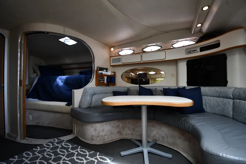 Slide: The Image of Interior of 1994 Sea Ray 400 Express Cruiser with cozy seating and sleeping area. - 30