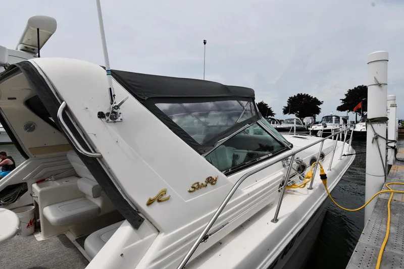 Slide: The Image of 1994 Sea Ray 400 Express Cruiser docked at marina, featuring sleek design and comfortable seating. - 2