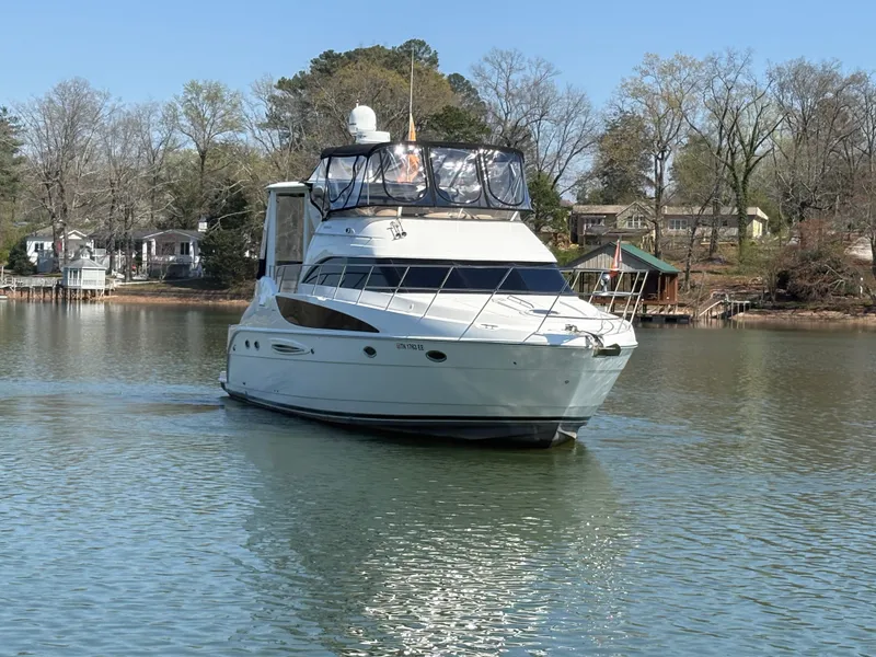 Slide: The Image of 2007 Meridian 459 Motoryacht anchored on a calm lake. - 2
