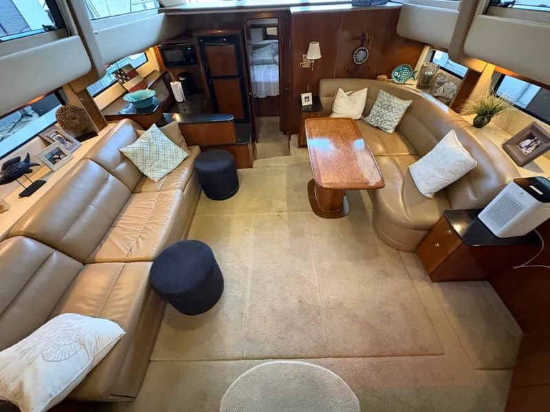 Slide: The Image of Interior of a 2007 Meridian 459 Motoryacht with leather sofas and wooden table. - 30