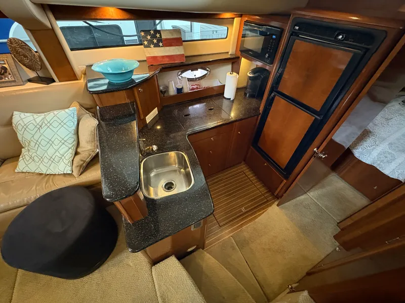 Slide: The Image of Interior of 2007 Meridian 459 Motoryacht with kitchen and seating area. - 33