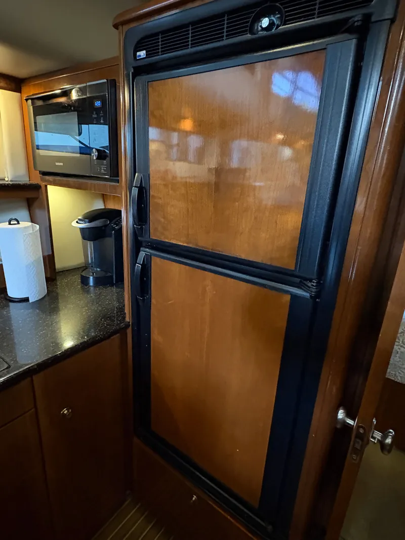 Slide: The Image of 2007 Meridian 459 Motoryacht kitchen area with fridge and microwave. - 35
