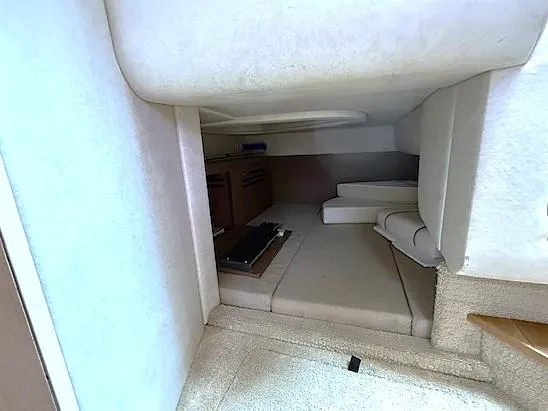 Slide: The Image of Interior cabin of 2013 Sea Ray 260 Sundancer, featuring cozy seating and storage. - 18