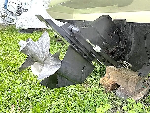 Slide: The Image of 2013 Sea Ray 260 Sundancer boat propeller on grass, supported by wooden blocks. - 25