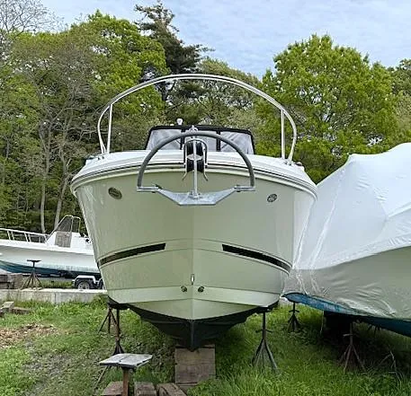 Slide: The Image of 2013 Sea Ray 260 Sundancer boat on stands, surrounded by trees. - 4