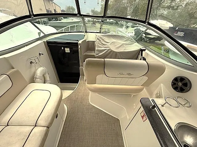 Slide: The Image of 2013 Sea Ray 260 Sundancer boat interior with seating and helm area. - 5