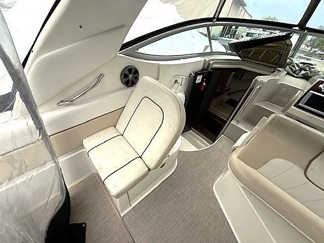Slide: The Image of 2013 Sea Ray 260 Sundancer interior with beige seating and modern design. - 9