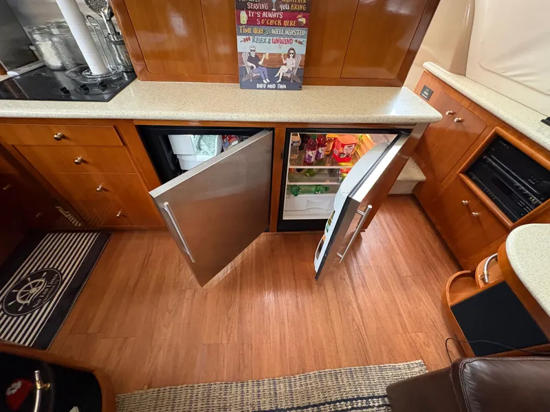 Slide: The Image of Carver 530 Voyager Pilothouse kitchen with open fridge. - 10
