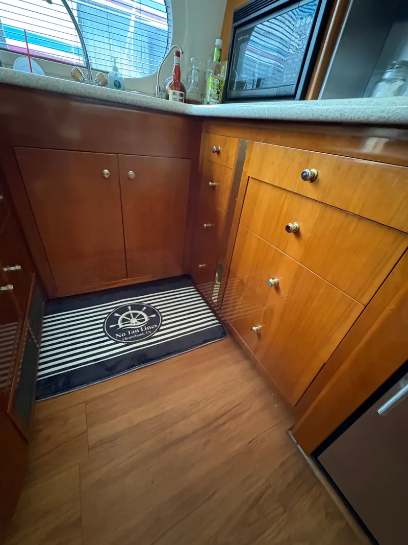 Slide: The Image of Interior of Carver 530 Voyager Pilothouse yacht, kitchen with wooden cabinetry. - 11