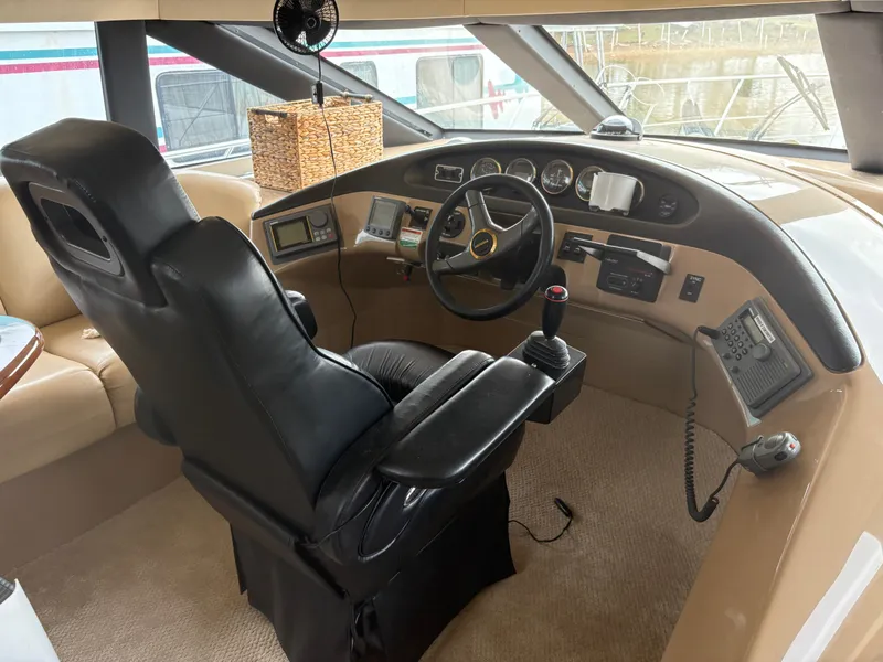 Slide: The Image of Interior of 2000 Carver 530 Voyager Pilothouse with steering wheel and instruments. - 12