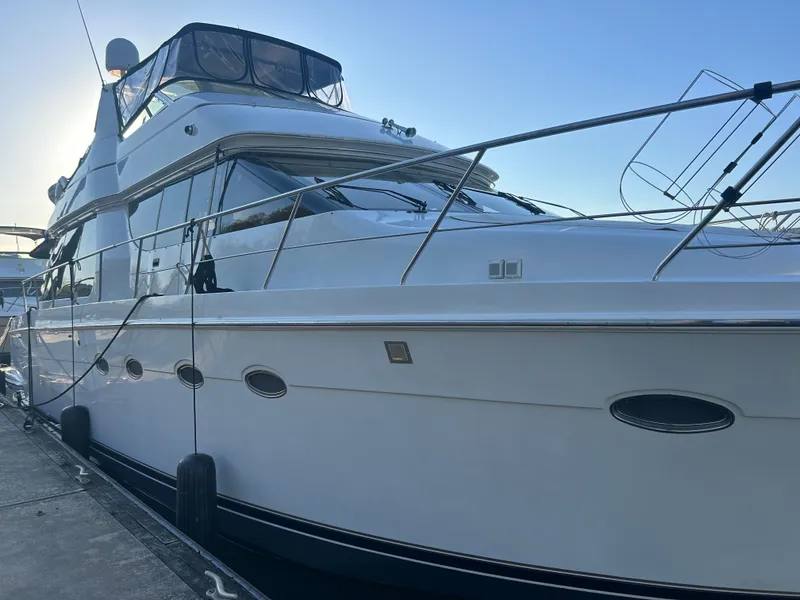 Slide: The Image of 2000 Carver 530 Voyager Pilothouse yacht docked at marina. - 2