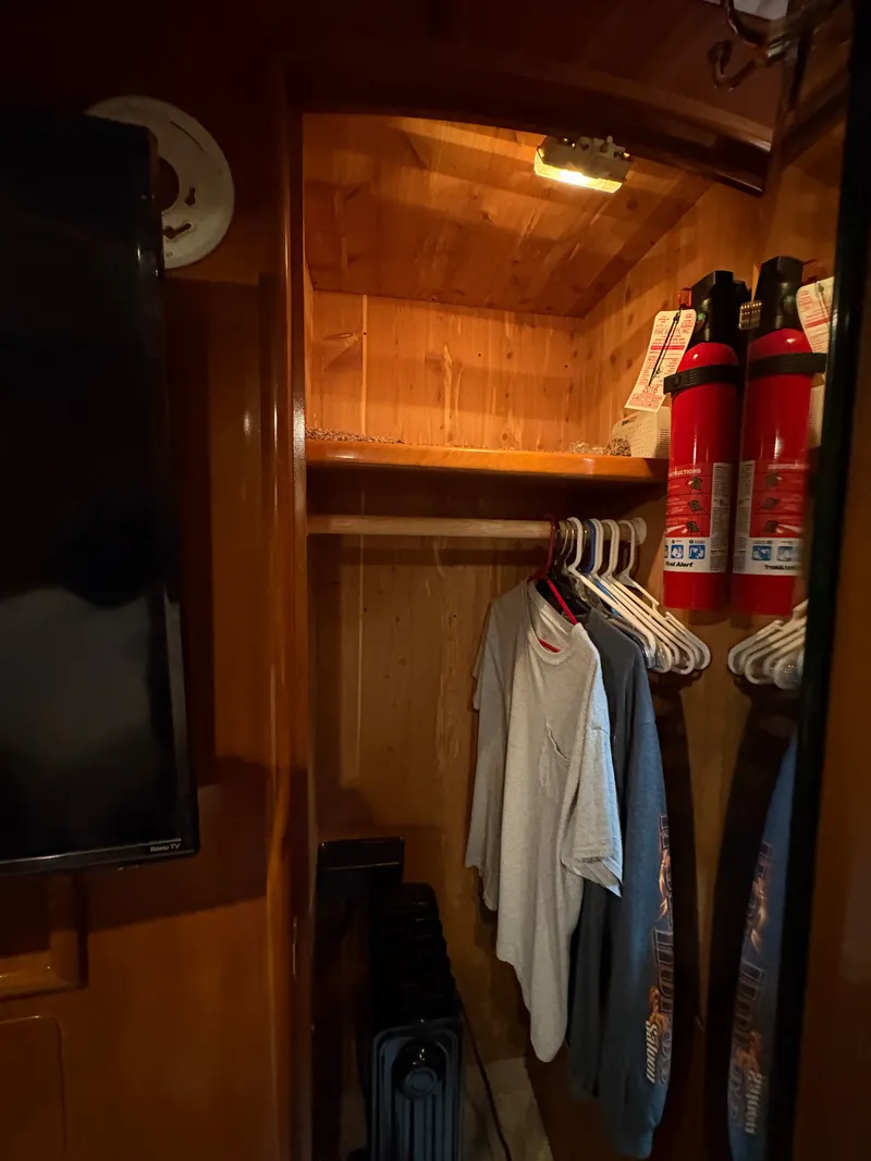 Slide: The Image of Interior of Carver 530 Voyager Pilothouse with closet and fire extinguishers. - 29