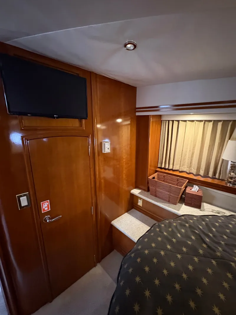 Slide: The Image of Interior of 2000 Carver 530 Voyager Pilothouse with wood paneling and TV. - 46